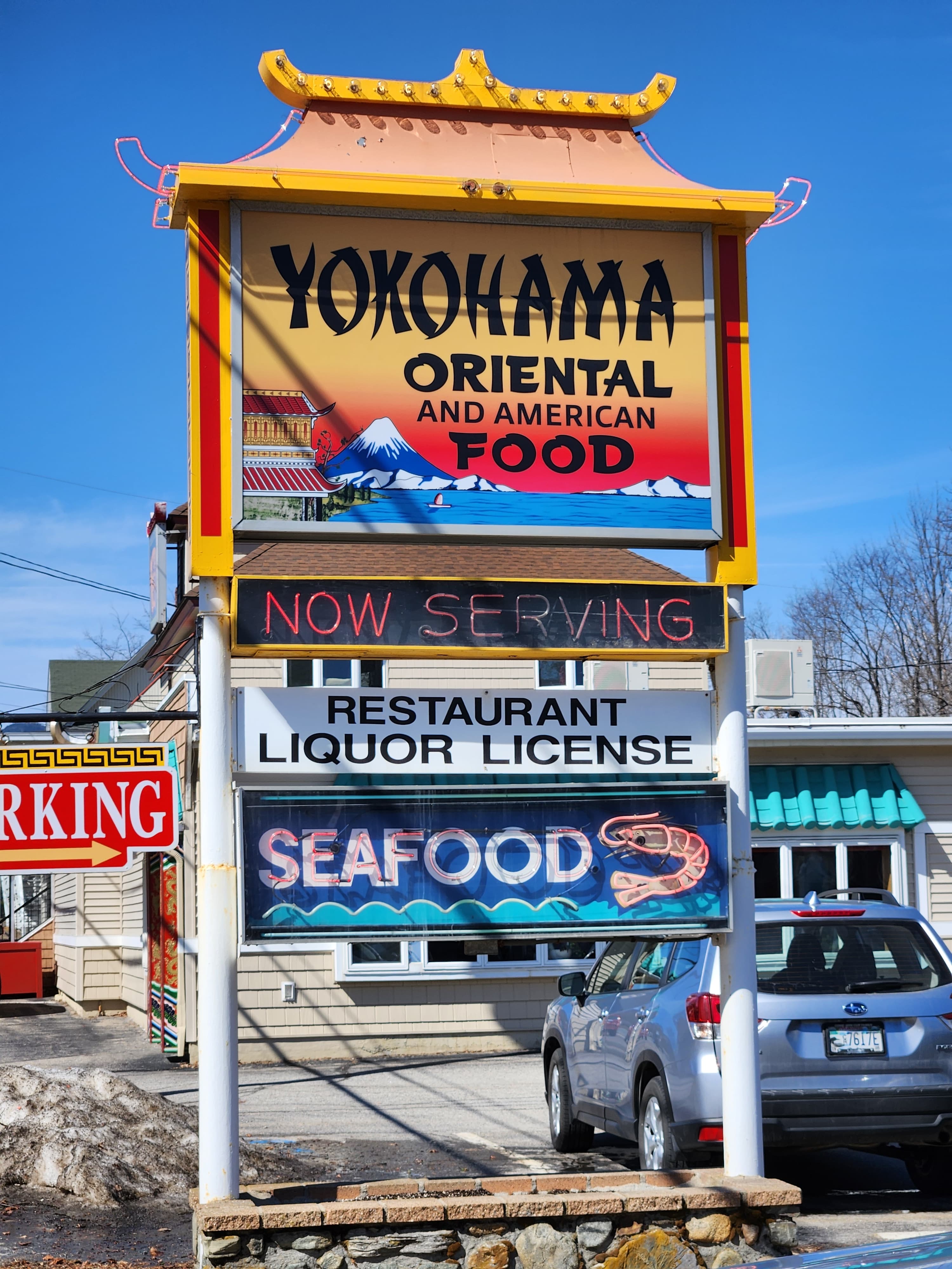 Sign for Yokohama restaurant offering Oriental and American food, including seafood, with a liquor license.