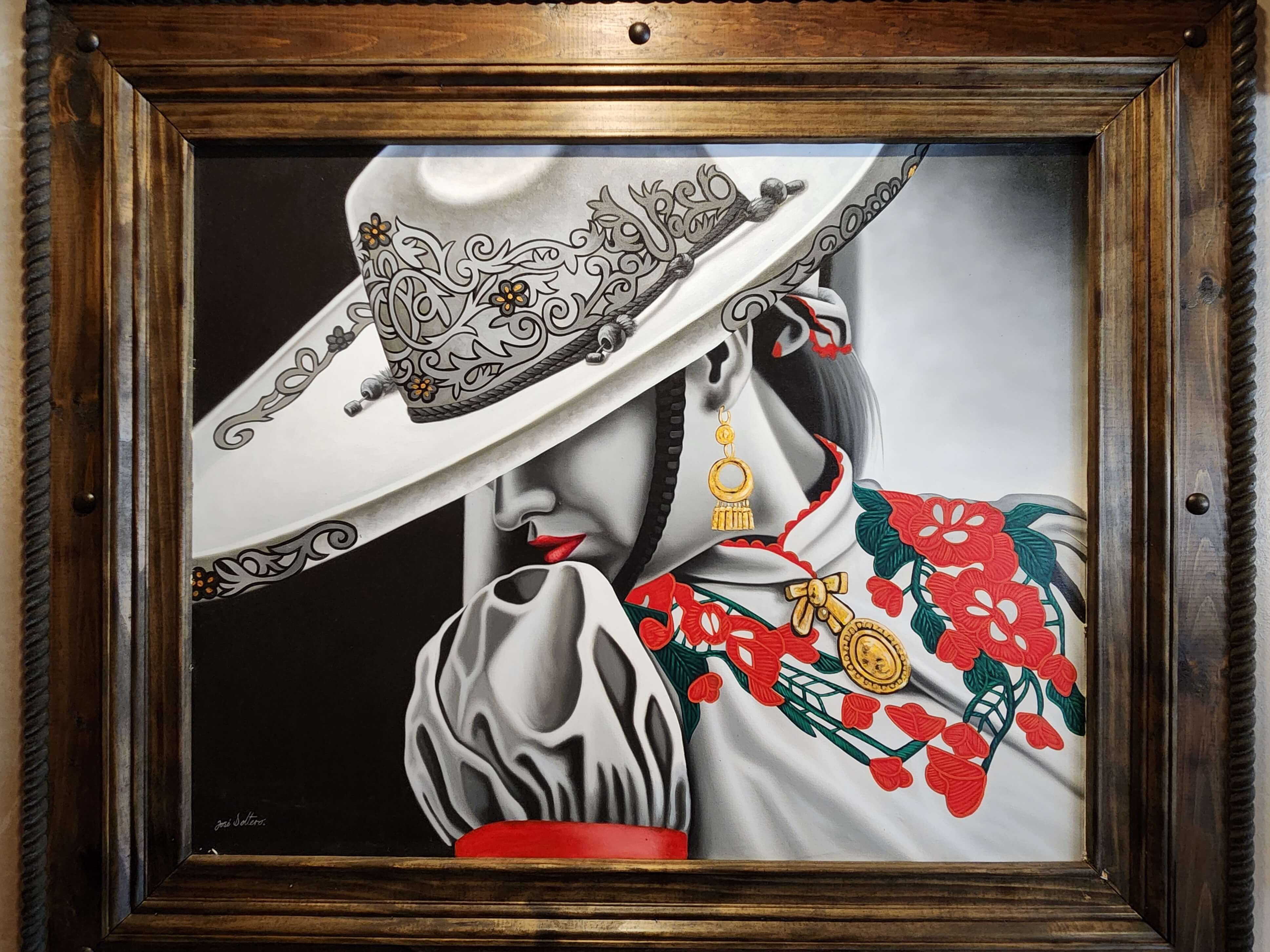 A detailed portrait of a woman in traditional attire, wearing an ornate sombrero and surrounded by vibrant floral patterns.