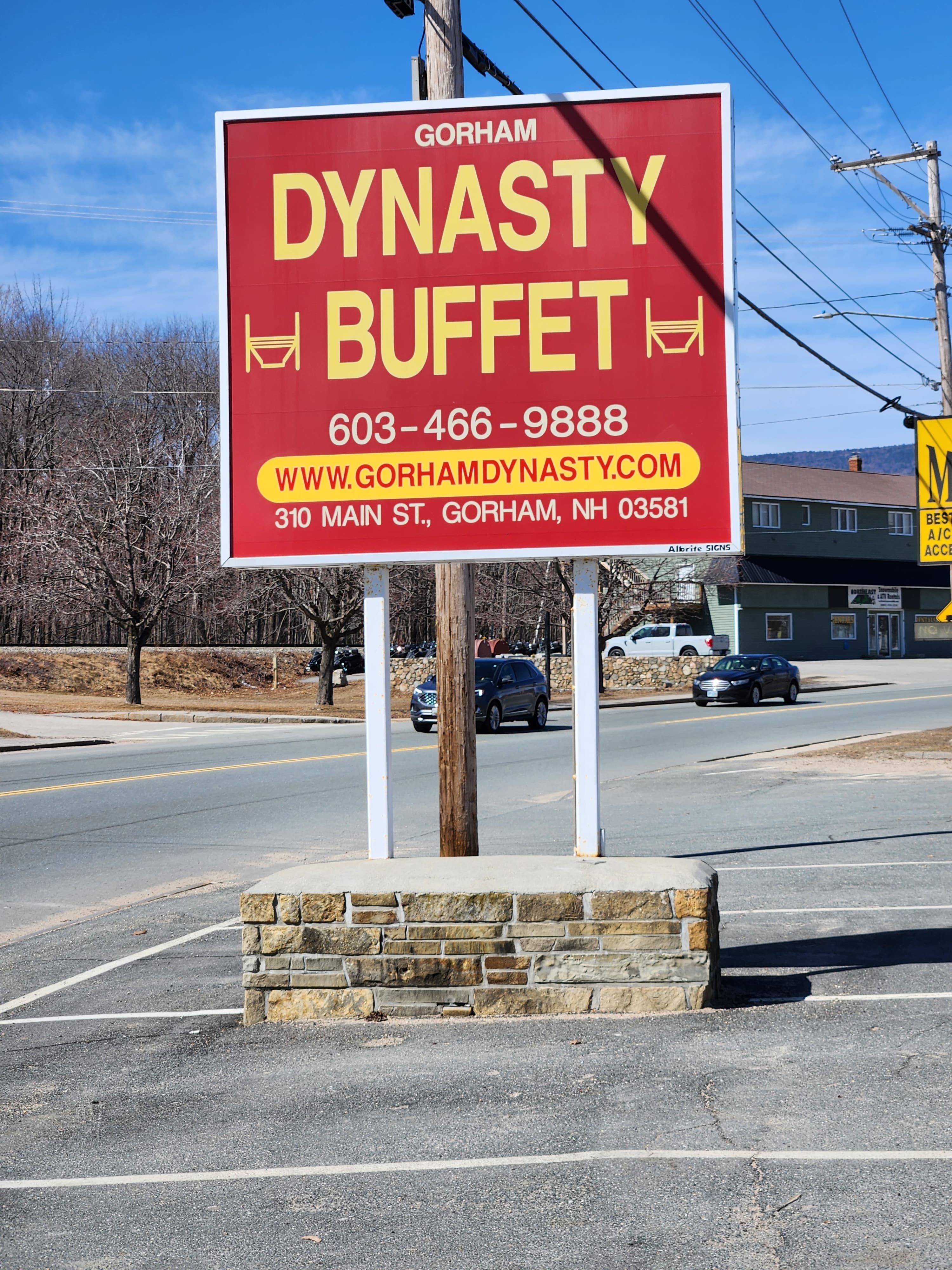 Sign for Dynasty Buffet in Gorham, NH, featuring contact information and website.